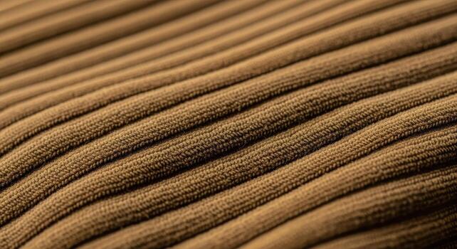 Close-up of a textured brown corduroy fabric, showcasing the pattern and detail of the textile material with a rich, earthy tone and diagonal orientation photo