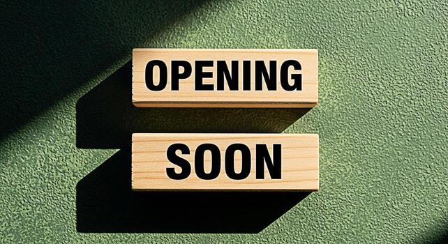 Wooden blocks displaying the message Opening Soon on a textured green background casting shadows symbolizing anticipation and excitement for a new business or event creating a sense of expectation photo