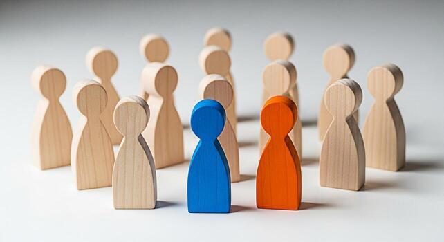 Wooden figurines standing out from the crowd on a white surface representing individuality leadership and diversity in a group symbolizing uniqueness and standing out from the rest with a sense of bel photo