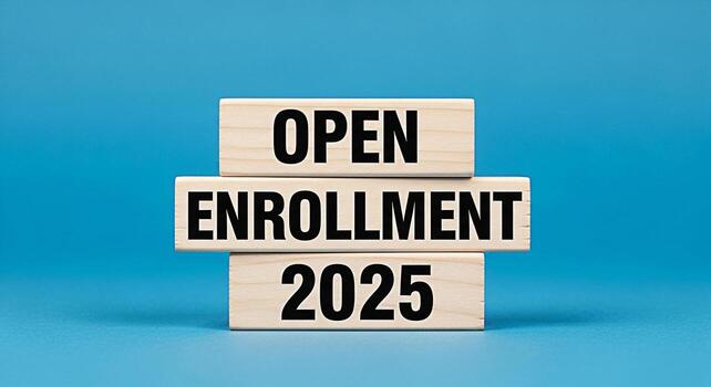 Wooden blocks stacked against a blue background announcing the Open Enrollment period for 2025 symbolizing opportunity and planning for the future with a clear and concise message photo