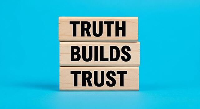 Stacked wooden blocks displaying the message Truth Builds Trust against a vibrant blue background symbolizing transparency integrity and the foundation of strong relationships in business and personal photo