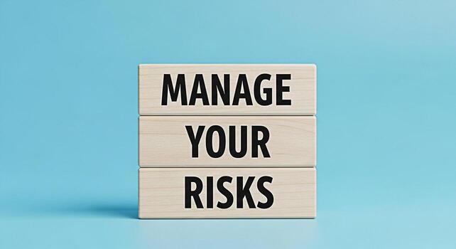 Stacked wooden blocks displaying the message Manage Your Risks in a studio setting against a light blue background symbolizing strategic planning risk management and proactive decisionmaking for busin photo