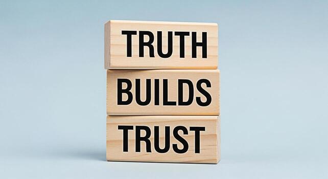 Stacked wooden blocks displaying Truth Builds Trust against a soft blue background symbolizing integrity reliability and the importance of honesty in fostering strong relationships and building a trus photo