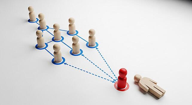 Wooden figures connected by blue lines symbolizing a network with one red figure standing out and another fallen representing leadership competition and the consequences of failure in a business envir photo