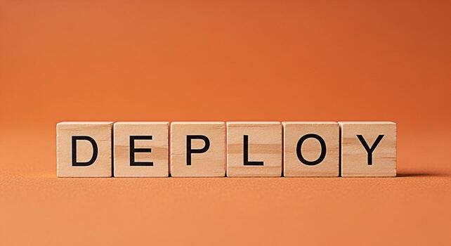 Wooden blocks spelling DEPLOY on a textured orange surface symbolizing implementation and release in a clean studio setting conveying a sense of readiness and strategic execution for business and tech photo