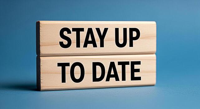 Wooden blocks displaying Stay Up To Date on a blue surface symbolizing the importance of continuous learning and adaptation in a rapidly changing world fostering a sense of progress and future readine photo