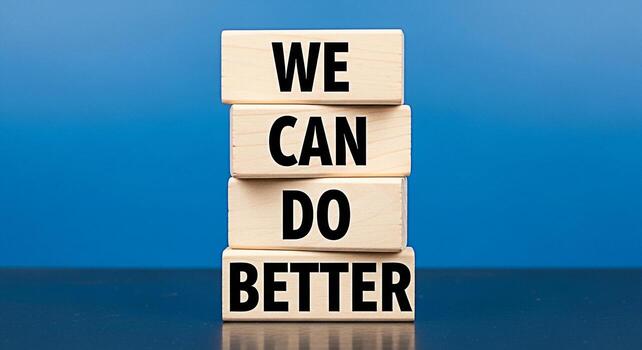 Stacked wooden blocks displaying the message We Can Do Better against a vibrant blue background symbolizing motivation improvement and a positive mindset for personal and professional growth photo