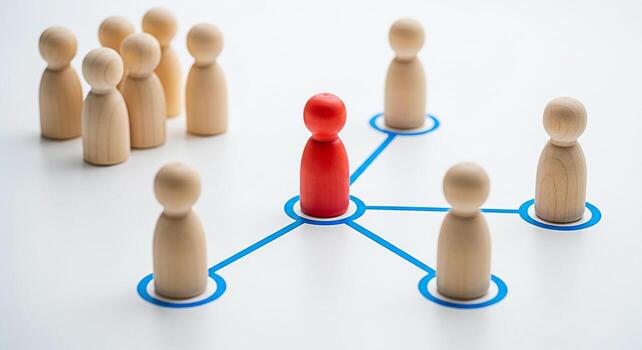 Red wooden figure connecting with other wooden figures on a white surface representing leadership networking and communication in a business or social context symbolizing connection and teamwork photo
