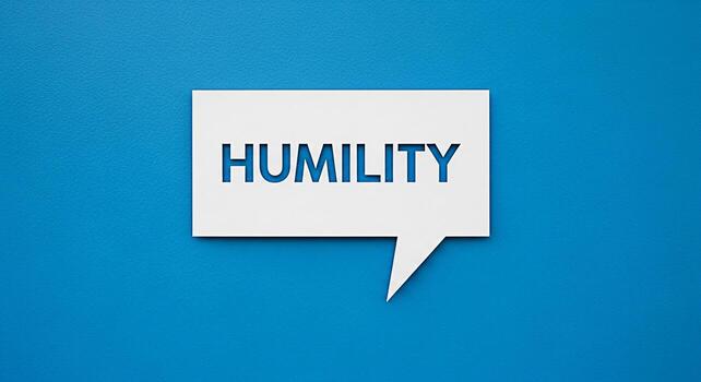 White speech bubble displaying the word HUMILITY against a vibrant blue background symbolizing a message of modesty and selfawareness in communication fostering a culture of understanding and respect photo