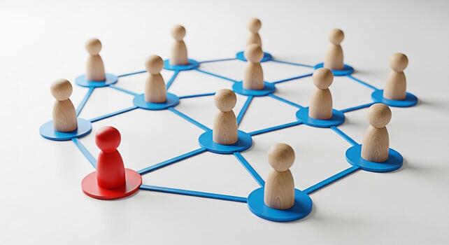 Wooden figures connected by blue lines on a white surface representing a network with one red figure standing out symbolizing leadership individuality and unique talent in a collaborative environment photo