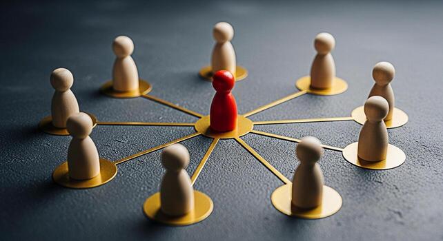 Wooden figures connected by golden lines on a gray surface symbolizing leadership and networking showcasing a strong connection and communication in a business environment conveying a sense of unity a photo