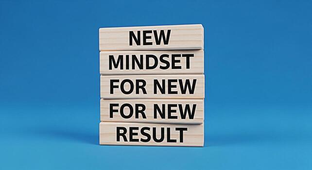 Stacked wooden blocks displaying the message New Mindset for New Result against a vibrant blue background symbolizing positive change growth and the power of a fresh perspective in achieving goals photo
