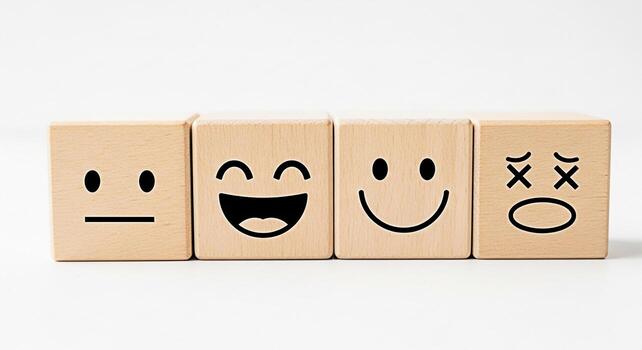 Wooden blocks displaying diverse emotions on a clean white surface representing a spectrum of feelings from neutral to joyful and sad conveying the concept of emotional intelligence and mental wellbei photo