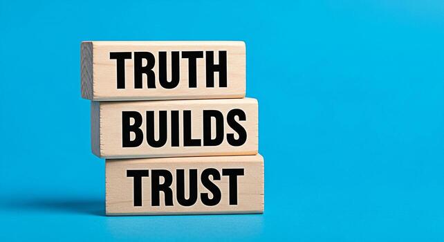 Wooden blocks stacked high on a vibrant blue background displaying the message Truth Builds Trust symbolizing integrity reliability and the foundation of strong relationships in business and personal photo