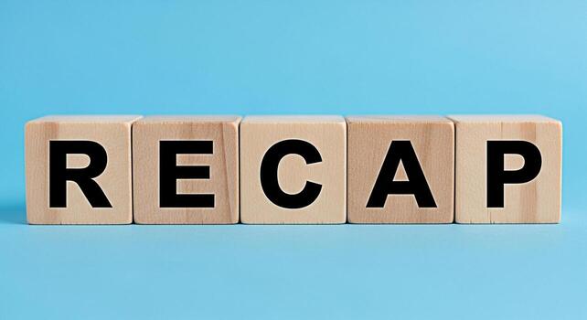 Wooden blocks spelling RECAP on a light blue background representing a summary or review of past events conveying a sense of reflection and closure ideal for business reports and educational materials photo
