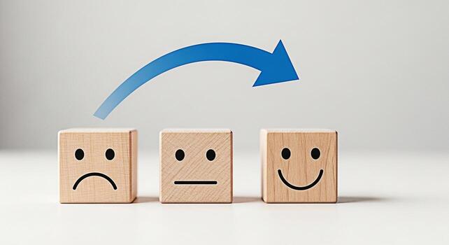 de madera bloques mostrando un progresión de emociones desde triste a contento guiado por un azul flecha en un blanco superficie simbolizando positivo cambio y mejorado cliente satisfacción mediante realimentación y servi foto