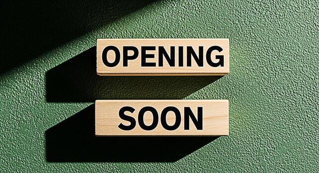Wooden blocks displaying Opening Soon on a textured green background casting shadows symbolizing anticipation and excitement for a new business venture or event creating a buzz and generating interest photo
