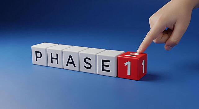 Hand pointing to a red block labeled Phase 1 on a blue surface symbolizing the initial stage of a project highlighting the concept of starting planning and achieving milestones with a focused and dete photo