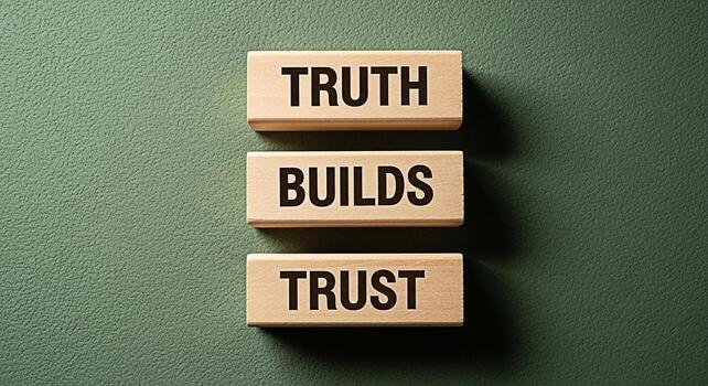 Wooden blocks stacked on a textured green surface displaying the message Truth Builds Trust symbolizing the importance of honesty and integrity in building strong relationships and fostering a trustwo photo