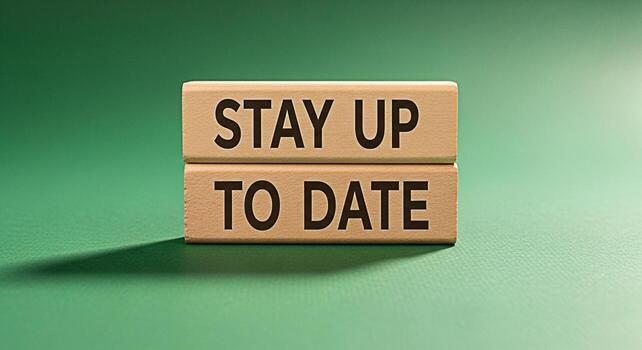 Wooden blocks displaying Stay Up To Date on a green surface symbolizing the importance of continuous learning and adaptation in a rapidly changing world fostering a sense of progress and futurereadine photo