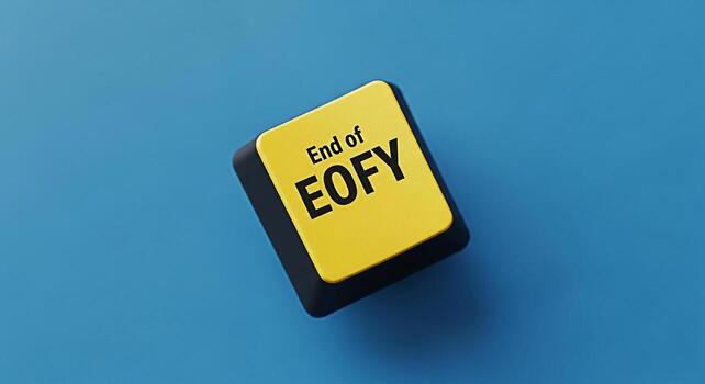 Closeup of a yellow computer key with the text End of EOFY on a blue background symbolizing the end of the financial year deadlines and the urgency of completing tasks before the fiscal year ends photo