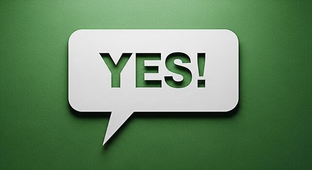 A white speech bubble with the word YES cut out casting a shadow on a textured green background conveying a positive affirmative and decisive message with a clean and modern aesthetic photo