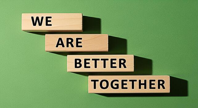 Wooden blocks displaying the message We Are Better Together on a green background symbolizing teamwork collaboration and the positive impact of unity in achieving common goals and fostering a supporti photo