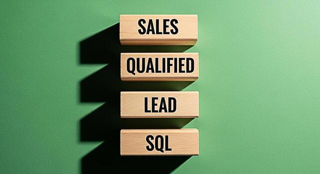 Wooden blocks displaying Sales Qualified Lead and SQL on a green surface representing business strategy and datadriven decisionmaking for achieving sales targets and improving customer relationships i photo