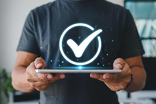 Man displaying a digital tablet with a glowing check mark in a modern office symbolizing approval and successful task completion with a positive and confident mood showcasing technology and efficiency photo