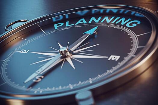 Closeup of a compass pointing towards PLANNING on a dark surface symbolizing strategic direction and business foresight in a corporate environment conveying a sense of focus guidance and future succes photo