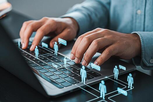 Closeup of hands typing on a laptop keyboard with digital avatars and chat bubbles representing online communication and social networking in a modern connected world conveying a sense of collaboratio photo