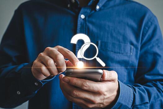 Man in a blue shirt using a smartphone to search for answers depicted with a question mark and magnifying glass conveying a sense of curiosity and problemsolving in the digital age illuminated by a br photo