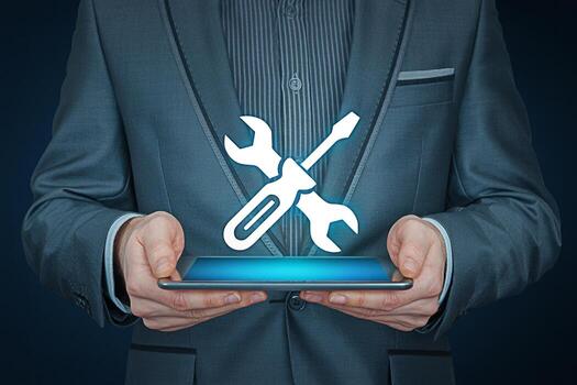 Professional man in a suit holding a tablet displaying a wrench and screwdriver icon symbolizing technical support and maintenance conveying a sense of reliability and digital solutions in a business photo