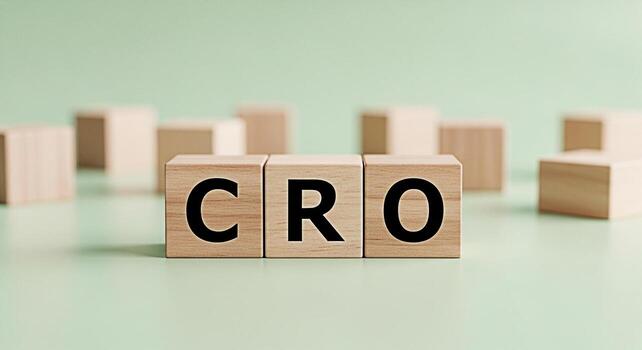 Wooden blocks spelling CRO on a light green surface representing conversion rate optimization strategies in a modern business environment conveying a sense of growth and success photo