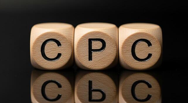 Wooden blocks displaying CPC on a reflective black surface representing cost per click advertising in a digital marketing environment symbolizing online business strategies and pay per click campaigns photo