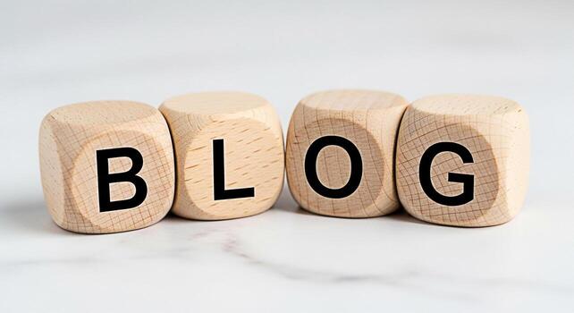 Wooden blocks spelling out BLOG on a white marble surface representing the concept of online content creation and digital marketing conveying a modern and informative mood for bloggers and content cre photo