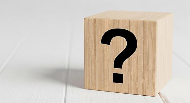 Wooden cube displaying a question mark on a white wooden surface symbolizing uncertainty and the need for answers in a clean minimalist setting evoking curiosity and problemsolving photo