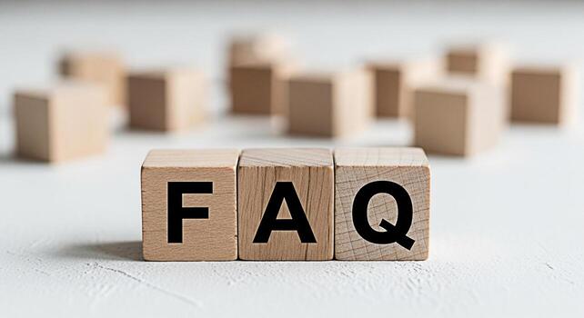 Wooden blocks spelling FAQ on a white textured surface representing frequently asked questions in a simple and clear presentation conveying information and support in a minimalist setting photo