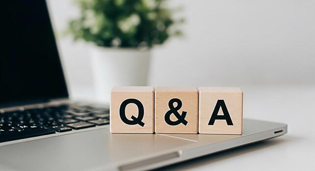 Wooden blocks displaying Q A on a laptop in a bright modern office symbolizing knowledge information and the importance of asking questions for learning and problemsolving in a digital environment photo