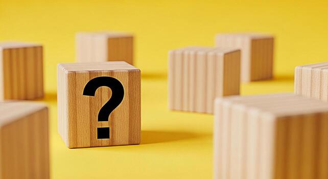 Wooden blocks displaying a question mark on a vibrant yellow background symbolizing uncertainty and the search for answers in a playful and engaging educational setting ideal for learning and problems photo