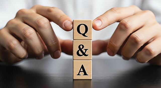 Person arranging wooden blocks with Q A on a dark surface representing questions and answers knowledge and information creating a sense of clarity and understanding in a business or educational settin photo