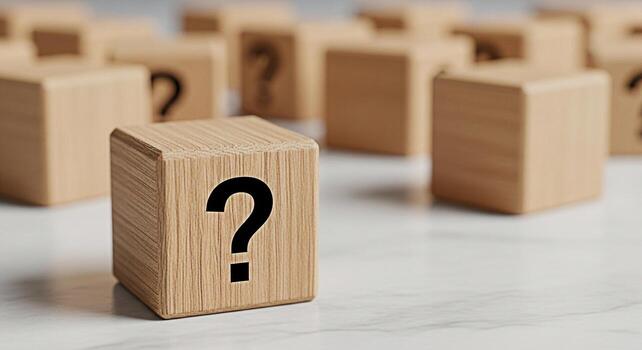 Wooden block displaying a question mark on a marble surface surrounded by other blurred blocks representing uncertainty problemsolving and the search for answers in a clean and minimalist setting photo