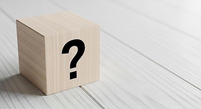 Wooden cube displaying a question mark symbol on a white wooden surface representing uncertainty inquiry and the search for answers in a clean and minimalist setting evoking curiosity and problemsolvi photo