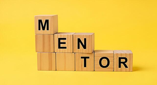 Wooden blocks spelling MENTOR stacked on a bright yellow background symbolizing guidance and support creating a positive and encouraging atmosphere for personal and professional development photo