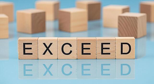 Wooden blocks spelling EXCEED on a reflective blue surface symbolizing ambition and achievement conveying a message of surpassing expectations and reaching new heights in a business environment photo