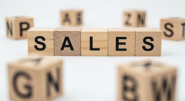 Wooden blocks spelling SALES on a white surface surrounded by other blocks with letters symbolizing business growth and success in a clean minimalist environment creating a sense of optimism and achie photo