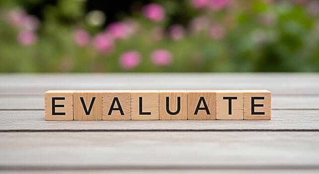 Wooden blocks spelling EVALUATE on a rustic wooden table in a garden setting symbolizing assessment analysis and decisionmaking with a focus on growth improvement and strategic planning for business s photo