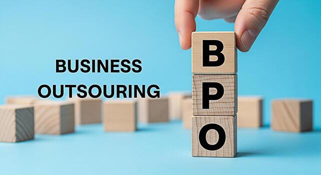 Hand placing a wooden block with the letter B on top of blocks spelling BPO in a bright minimalist studio setting symbolizing business process outsourcing and strategic business decisions for growth photo