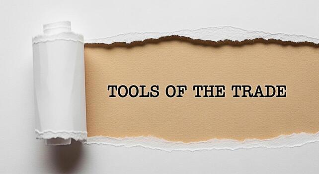 Torn paper revealing the phrase Tools of the Trade against a beige background symbolizing essential resources and expertise creating a sense of unveiling hidden knowledge and professional readiness photo