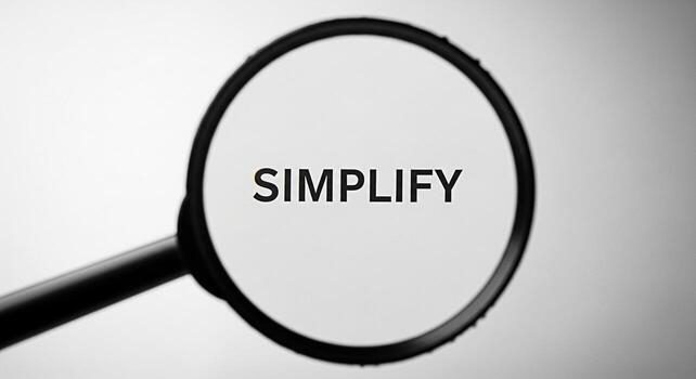 Magnifying glass focusing on the word Simplify against a clean white background emphasizing clarity and the concept of reducing complexity for better understanding and efficiency in business and perso photo
